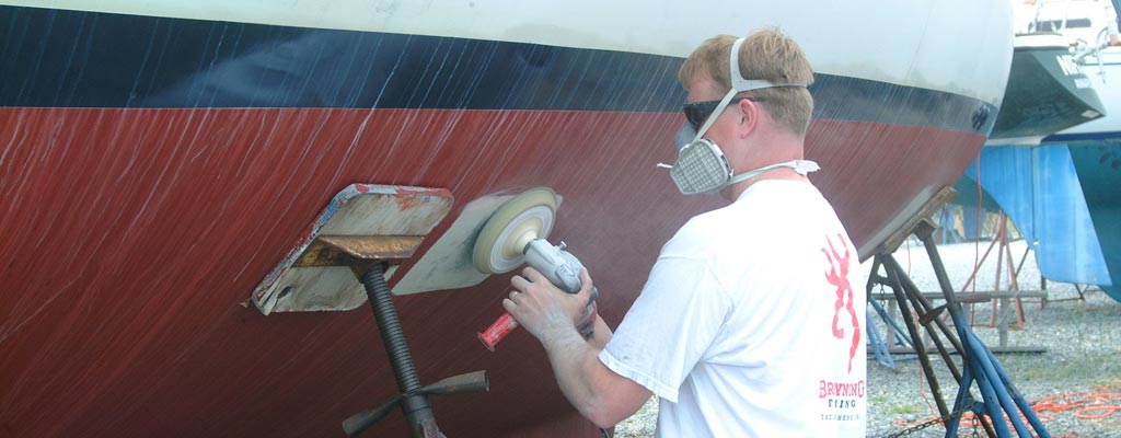 a man buffing the gel coat of a boat