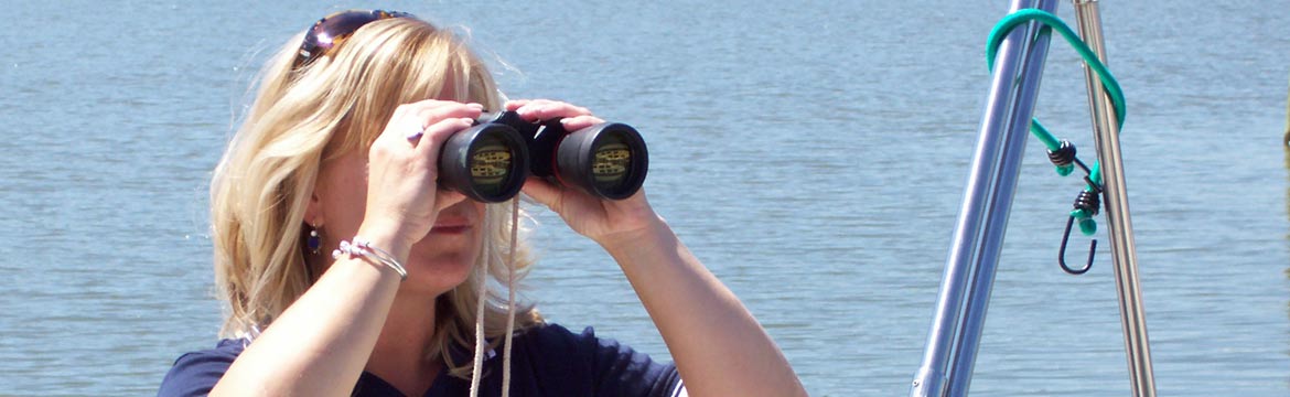 A woman spies the world through her large binoculars