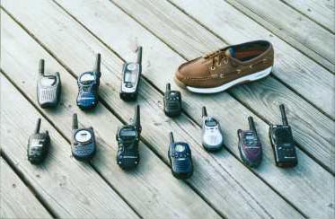 a shoe next to some hand-held radios