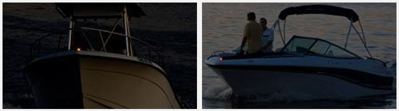 A dual console powerboat makes way with running lights luminated.