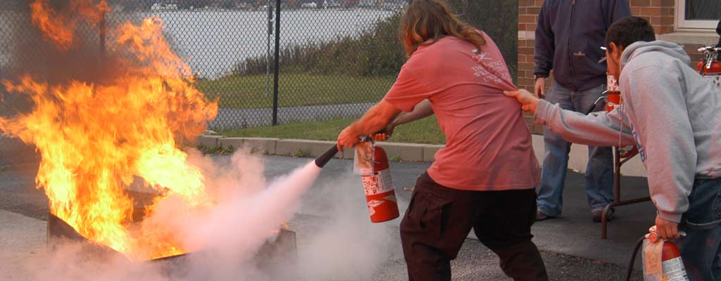 a man puts out a fire with an extinguisher