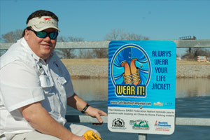 A sign being installed which reads, Wear It. Always wear your lifejacket.