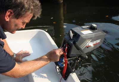 a man powering on an outboard motor