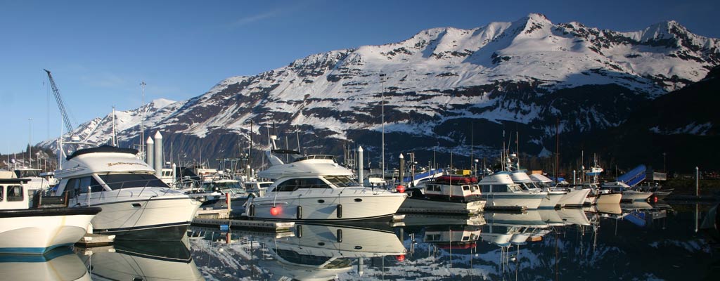 a boat in the distance on misty, cold water