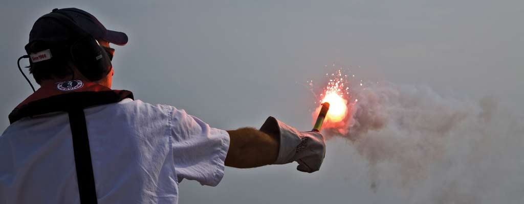 a person holding a red flare
