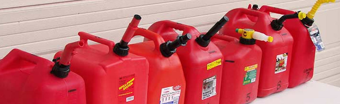 An assortment of red fuel jugs, also known as jerry jugs