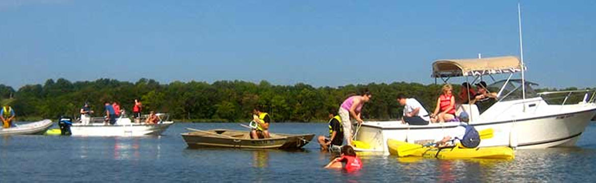 People pracice climbing onto a jon boat