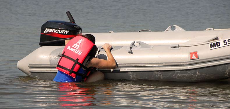 a man climbs aboard a rigid inflatable boat