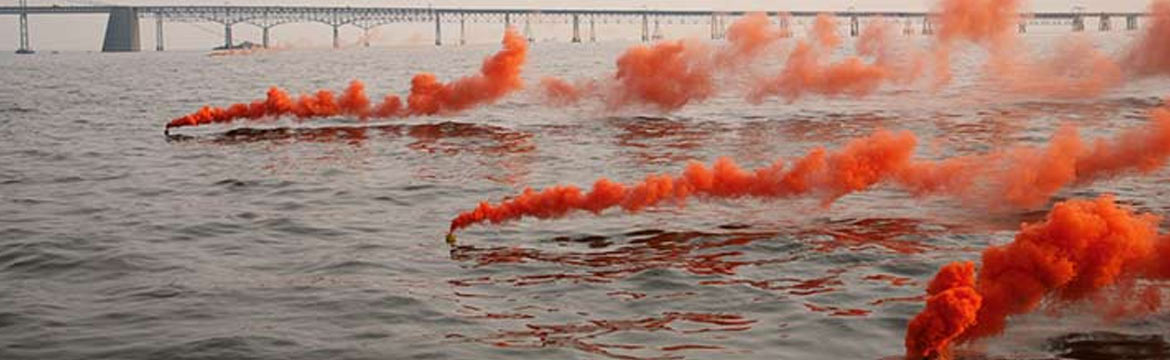 Three orange flares burning on the water