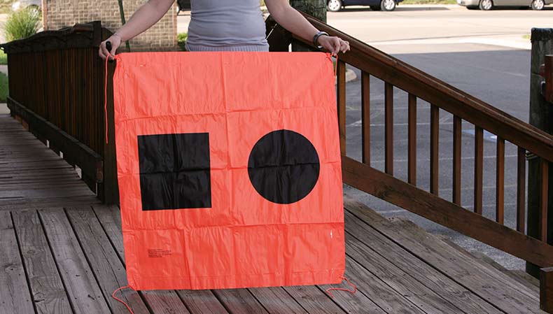 A tester is holding a distress signal flag