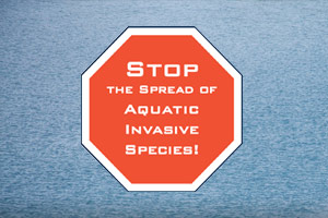 A stop sign reads, Stop the spread of Aquativ Invasive Species!