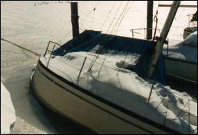 a boat half-sunk in snowy water