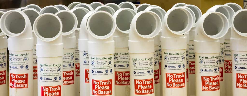a series of monofilament recycling bins