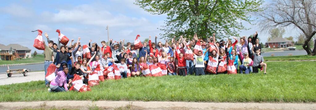 A group of kids celebrate their day cleaning up the waterway