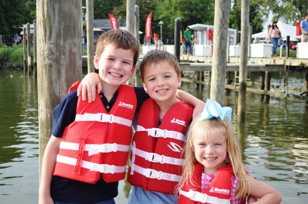 Photo of children in life jackets on a dock